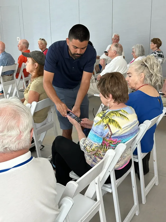 Erick Montano teaching a technology class to a group of seniors